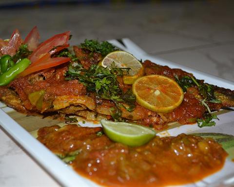 Serving inspiration: A whole baked fish in tomato sauce with herbs and lime slices. Not verified as this exact recipe.