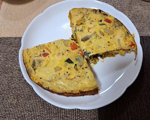 Serving inspiration: A sliced open-faced omelette with vegetables on a plate. Not verified as this exact recipe.