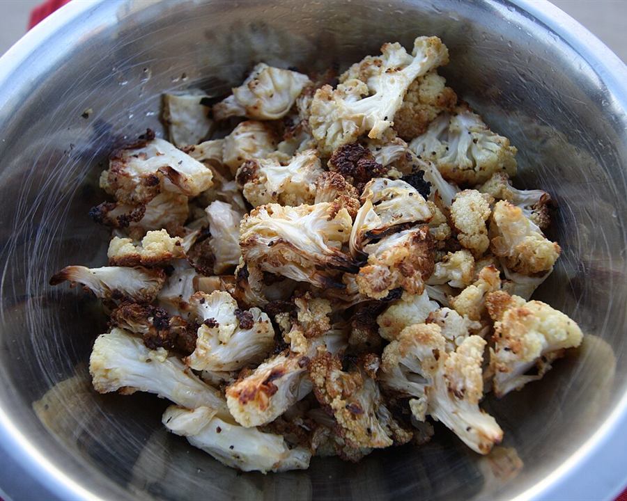 Roasted cauliflower florets in a metal bowl