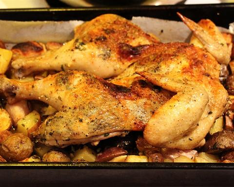 Serving inspiration: A roasted chicken on a bed of potatoes in a baking pan. Not verified as this exact recipe.