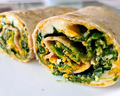 Serving inspiration: A tortilla wrap filled with spinach and egg, cut in half. Not verified as this exact recipe.