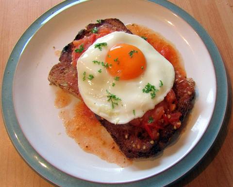 Serving inspiration: A fried egg on toast with tomato relish and fresh herbs on a plate. Not verified as this exact recipe.