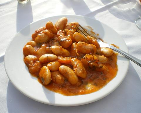Serving inspiration: Giant white beans baked in tomato sauce on a white plate. Not verified as this exact recipe.