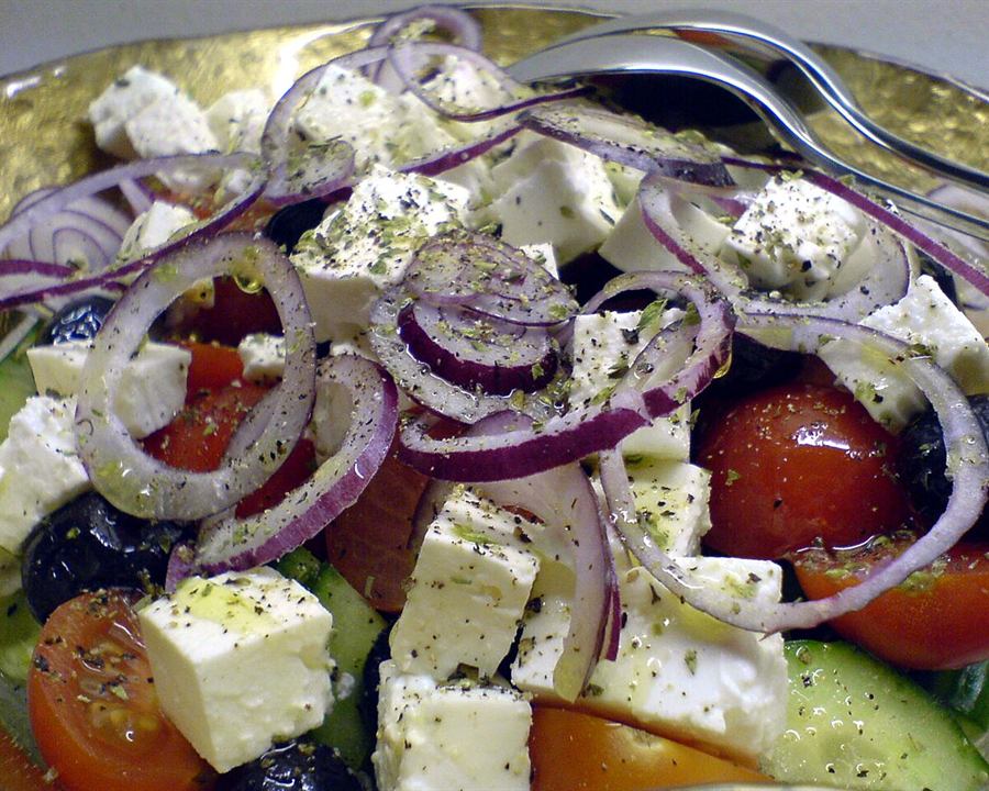 Greek salad with tomato, red onion, olives and cubes of feta