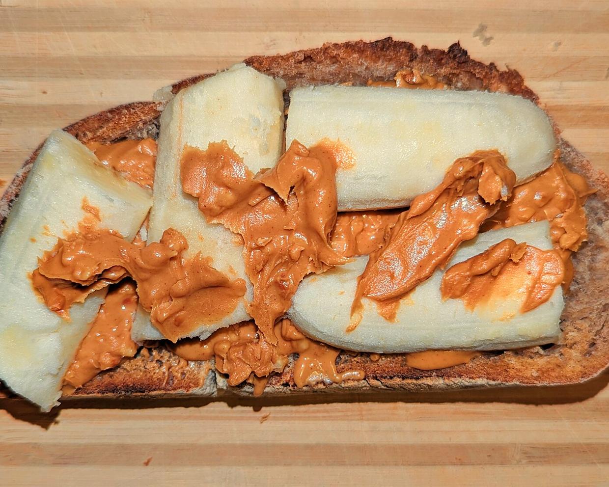Toasted bread spread with peanut butter and topped with banana slices