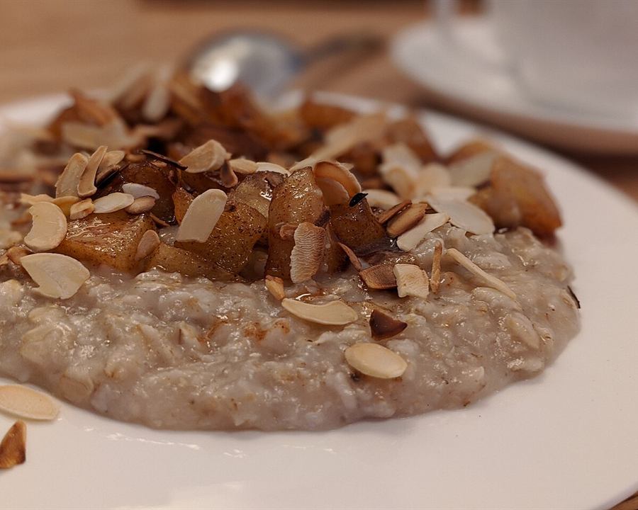 Oatmeal topped with caramelized apple and sliced almonds