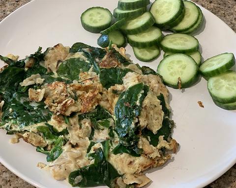 Serving inspiration: Scrambled eggs with spinach and sliced cucumber on a plate. Not verified as this exact recipe.