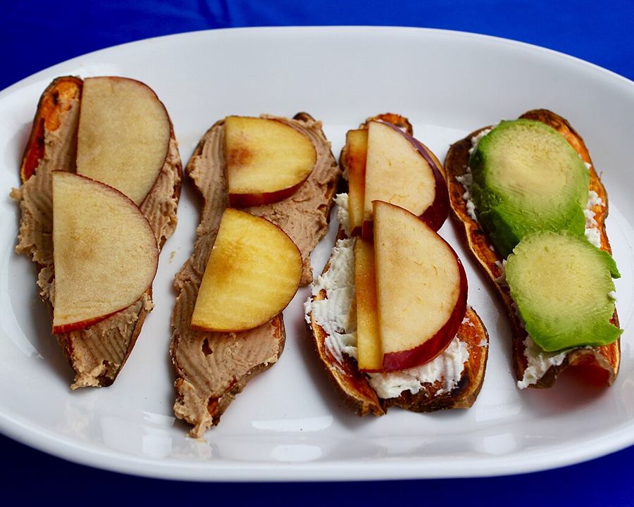Sweet potato toasts with toppings, served on a white plate