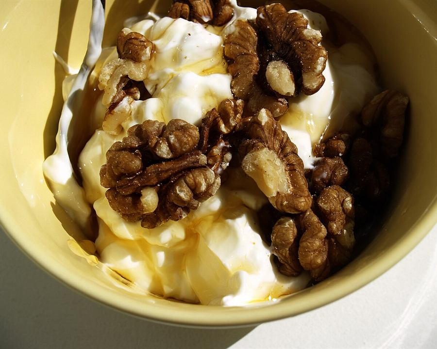 Serving inspiration: Greek yogurt drizzled with honey and topped with walnuts in a yellow bowl. Not this exact recipe.